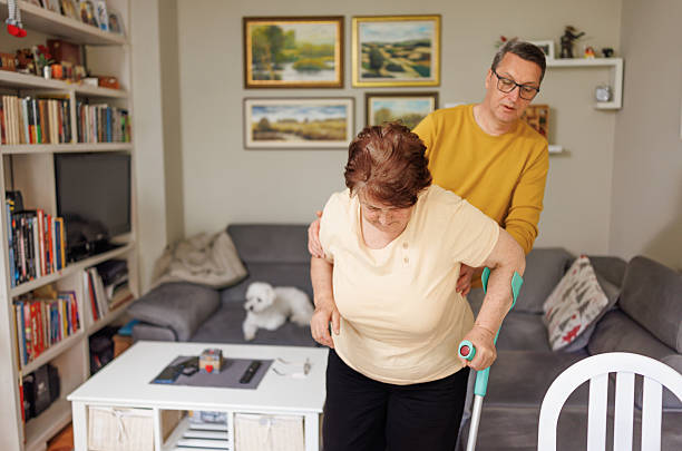 istock Son Providing Physical Assistance to Elderly Mother Using a Crutch 2213939158