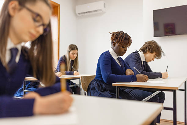 istock Students Focusing on Their Exams in Classroom 2213942283