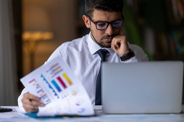 istock Professional Analyzing Financial Reports with laptop at Office Desk 2213942376