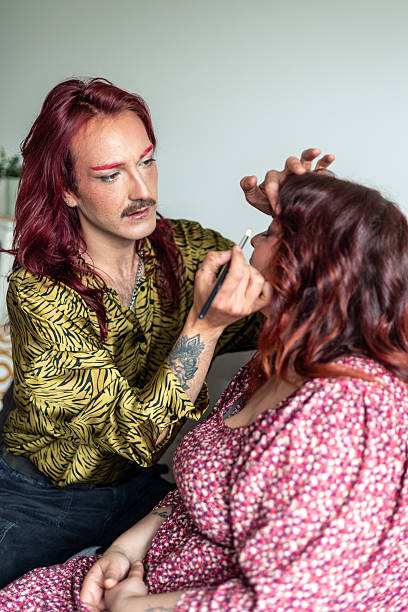 istock Non-binary makeup artist applying makeup on a curvy woman celebrating diversity 2213943096
