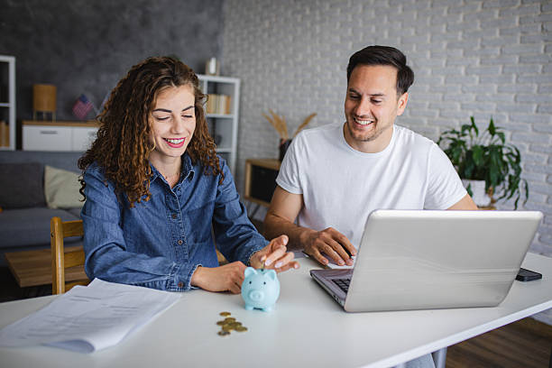 istock Young couple using laptop while planning their home budget 2213943680