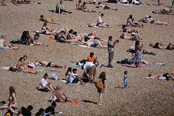 Drone photograph of sunbathers at Brighton Beach, England.