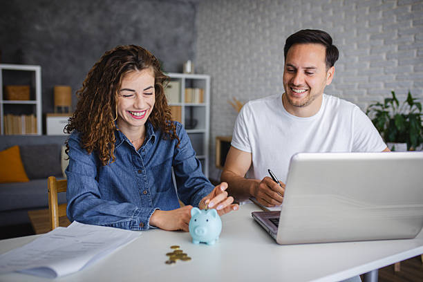 istock Young couple using laptop while planning their home budget 2213943801