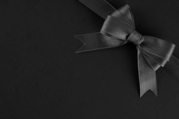 Black ribbon and bow on black background