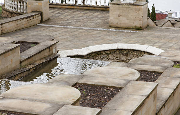 istock Cascading stone steps with flowing water in a classic garden 2213947251