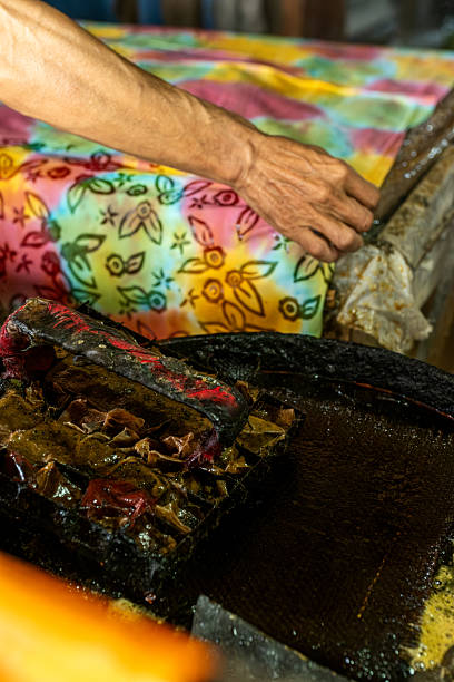 istock Artisan preparing batik fabric with traditional hot wax technique 2213948459