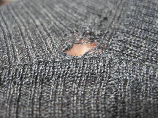istock Wool sweater with holes eaten by insects 2213949443