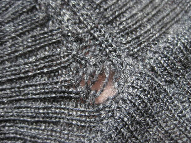 istock Wool sweater with holes eaten by insects 2213949460