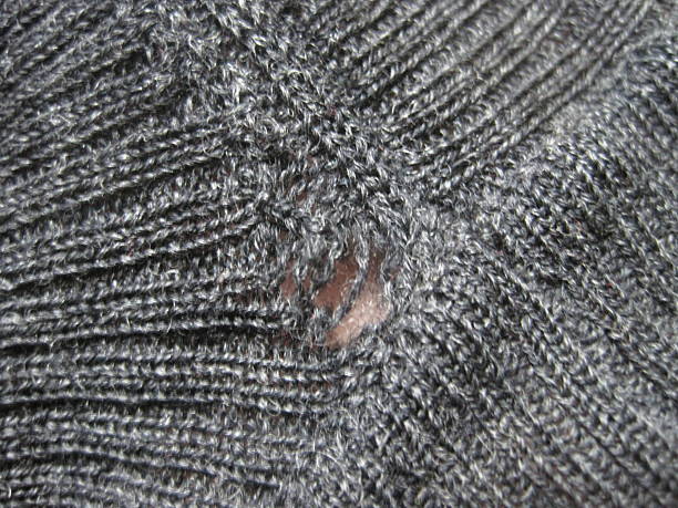 istock Wool sweater with holes eaten by insects 2213949469