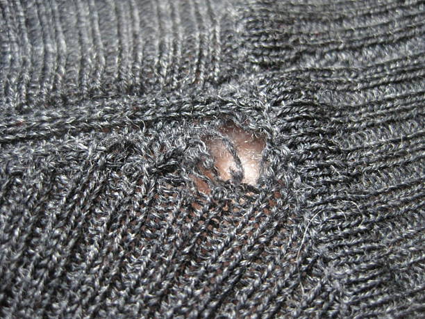 istock Wool sweater with holes eaten by insects 2213949473