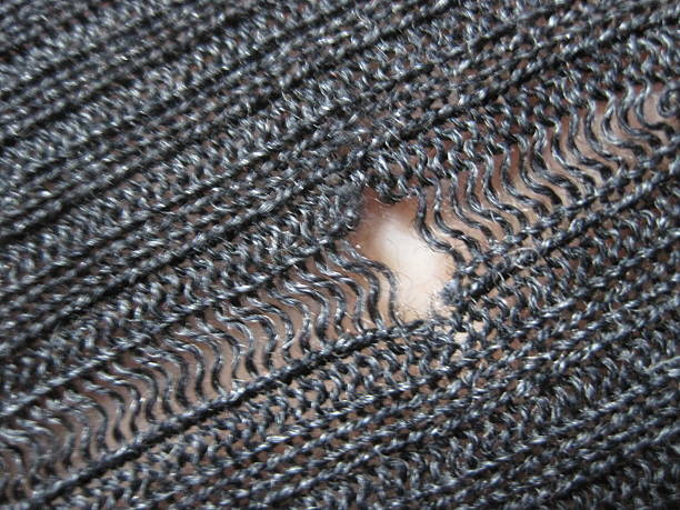istock Wool sweater with holes eaten by insects 2213949484