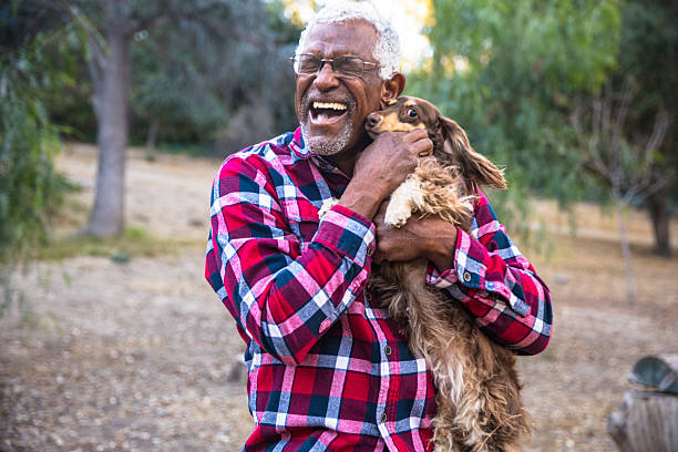 istock Senior black man with his dachshund dog 2213954339