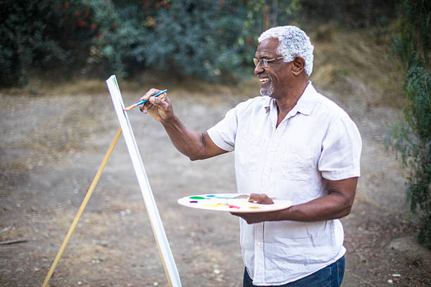 istock Senior black man painting in nature 2213954449