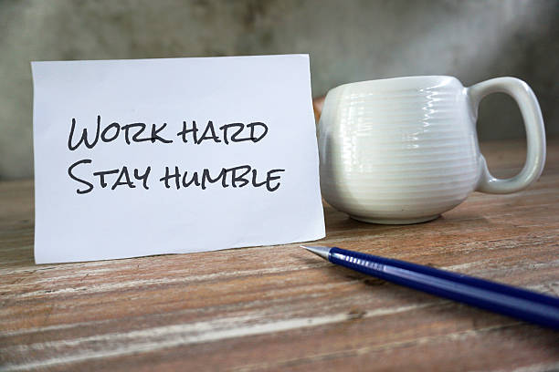 istock Motivation Text message on a paper - Work Hard and Stay Humble. 2213954941