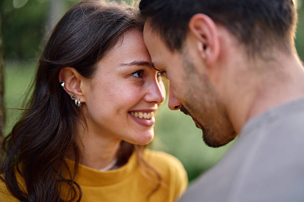 istock Young couple showing love and affection by touching foreheads 2213959790