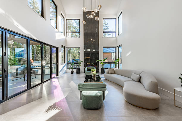 A very large modern contemporary private residence residential home spacious interiors living room, kitchen, office, recreation room, foyer, hallway, floating staircase window wall open to a patio with BBQ and swimming pool. New construction family home