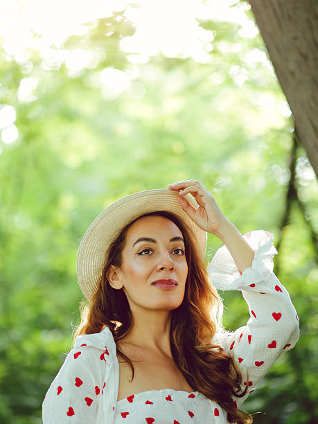 beautiful woman dressed in a heart-patterned outfit is enjoying the forest