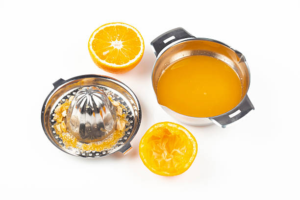 Steel citrus squeezer with a cut orange  isolated on white background