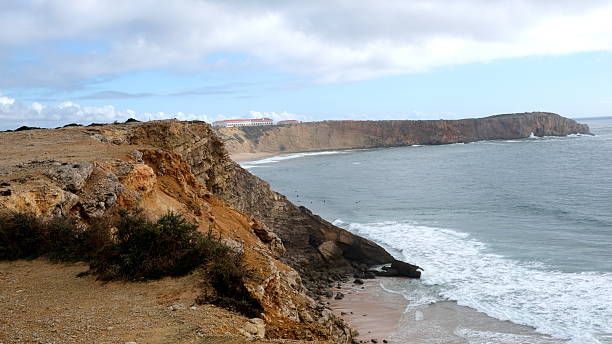 istock Surfer beach in a rocky environment 2213967525