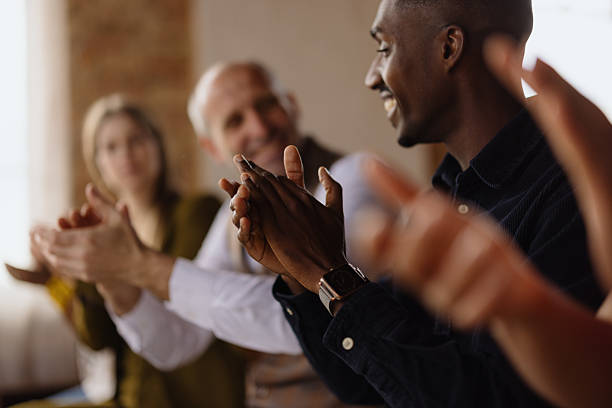 Closeup shot of an unrecognizable group of businesspeople applauding in an office