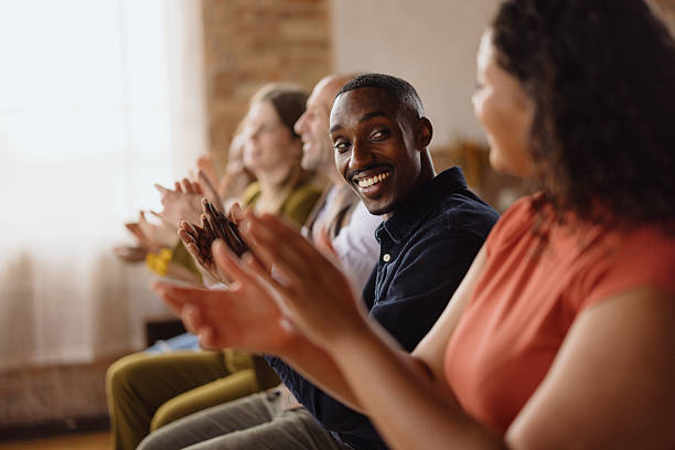istock Audience clapping hands and showing appreciation at a conference 2213968629