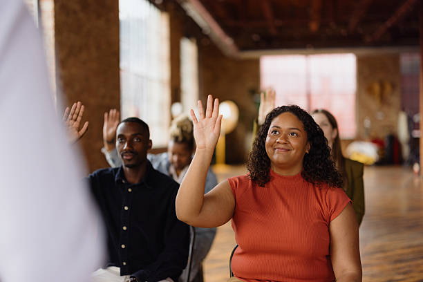 istock Students raising hands during a lesson in a classroom 2213968654