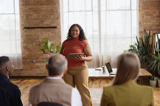 istock Confident businesswoman leading a meeting and using a digital tablet 2213969200