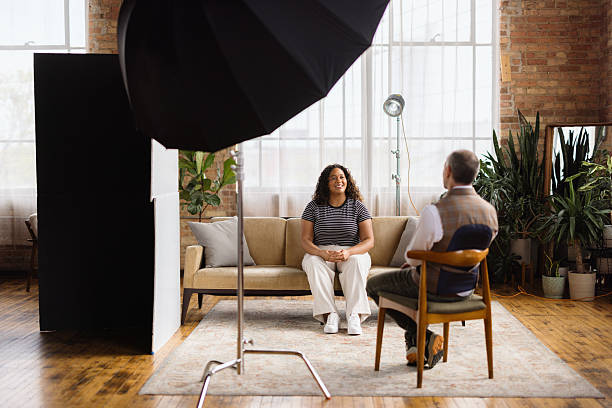 Woman being interviewed by journalist in modern loft studio