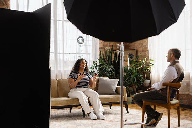 istock Young woman being interviewed by a man in a studio 2213970436