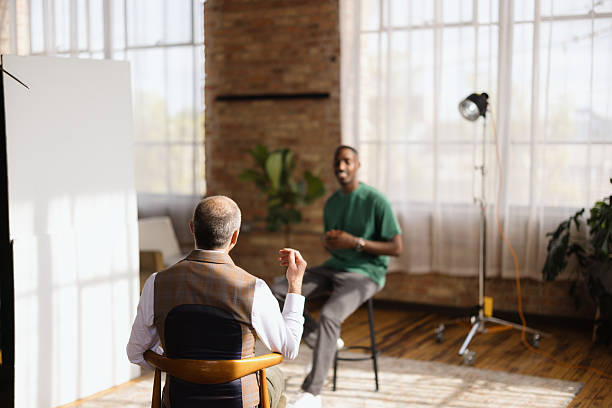 istock Interviewer listening to interviewee during a video interview in a loft studio 2213970449