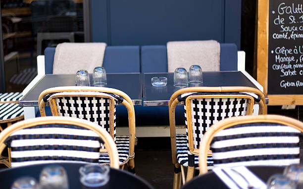 istock Paris, France: Sidewalk Cafe with Black and White Wicker Chairs 2213971137