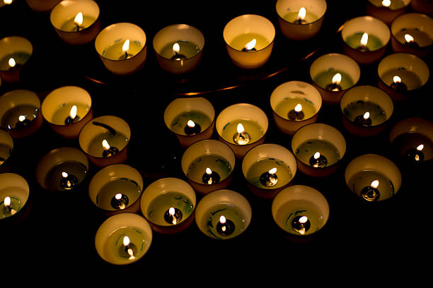 Paris, France: Many Lit Votive Candles on Black Background