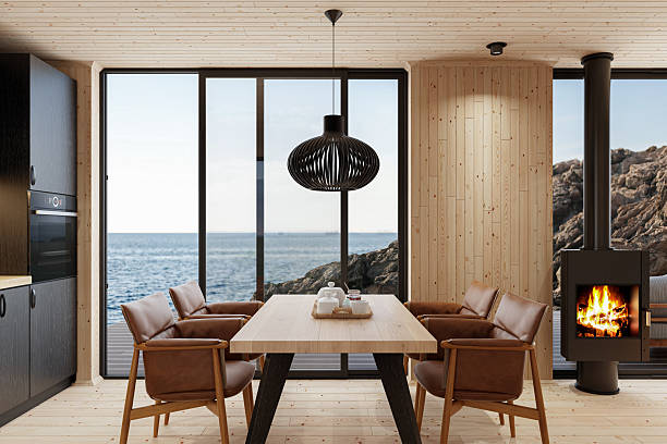 istock Compact Black Kitchen and Dining Area with Fireplace in Scandinavian Log Cabin and Sea View 2213976301