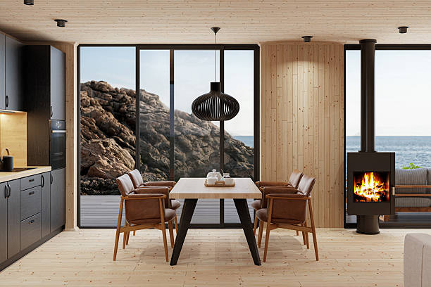 istock Compact Black Kitchen and Dining Area with Fireplace in Scandinavian Log Cabin and Sea View 2213976372