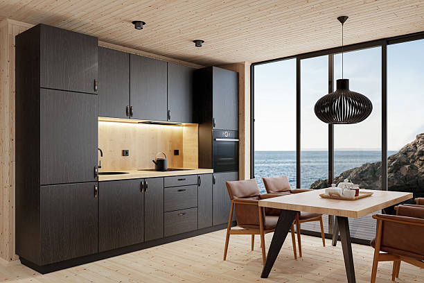 istock Compact Black Kitchen and Dining Area in Scandinavian Log Cabin with Sea View 2213976682