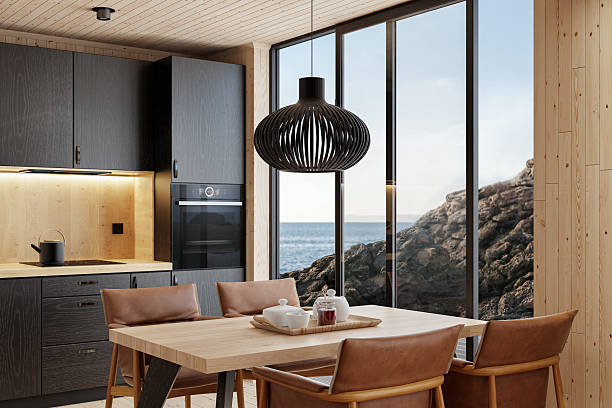 istock Compact Black Kitchen and Dining Area in Scandinavian Log Cabin with Sea View 2213976762