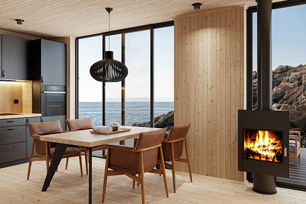 istock Compact Black Kitchen and Dining Area with Fireplace in Scandinavian Log Cabin and Sea View 2213976903