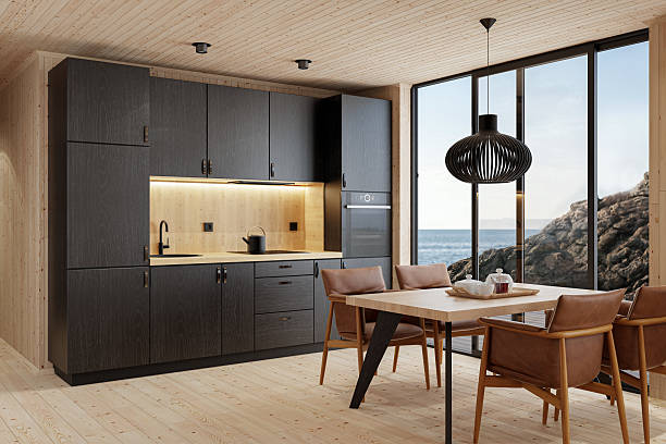 istock Compact Black Kitchen and Dining Area in Scandinavian Log Cabin with Sea View 2213976951