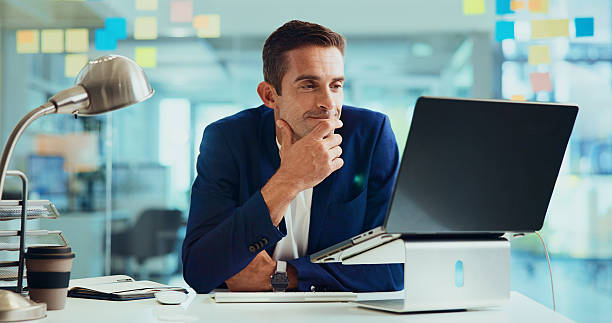 istock Business, laptop and man with internet, thinking and planning for project, decision and problem solving. Person, employee or consultant with idea, sales agency and computer for website info or choice 2213978872
