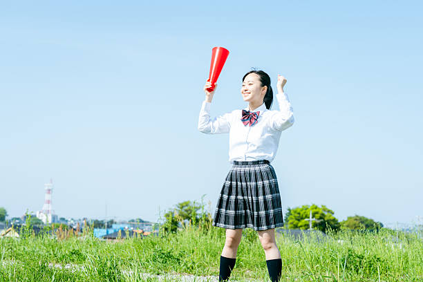 istock High school students cheering with megaphones 2213981182