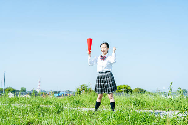 istock High school students cheering with megaphones 2213981184