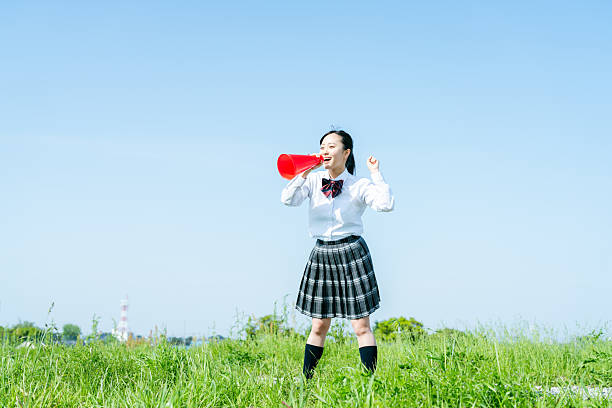 istock High school students cheering with megaphones 2213981185