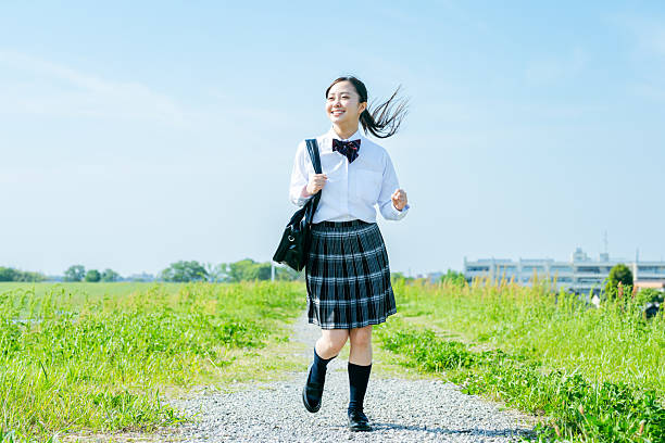 High school girl walking under the blue sky