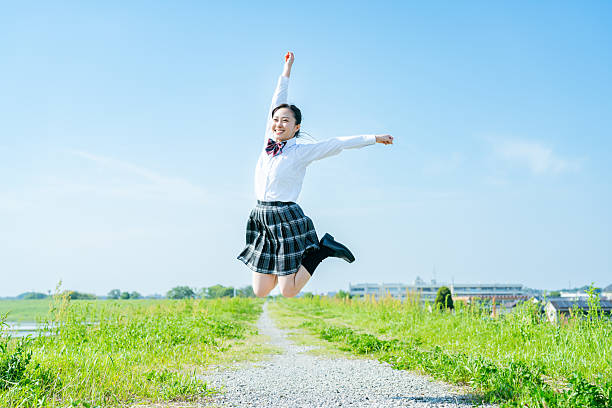 istock High school girl walking under the blue sky 2213981202