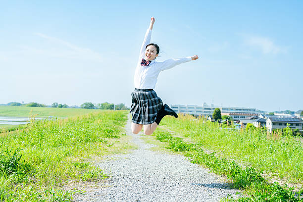 istock High school girl walking under the blue sky 2213981203