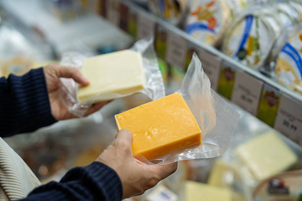 istock Selecting Fresh Cheese Blocks from the Grocery Store 2213985928