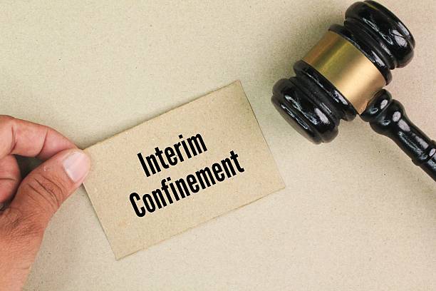 istock gavel and colored paper with the words interim confinement. Temporary Positions are intended for staffing of short term projects 2213987502