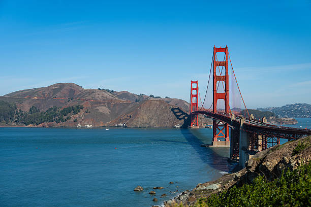 The iconic Golden Gate Bridge in San Francisco, California, spanning across the bay with its striking red towers. This world-famous suspension bridge is a must-see landmark, offering breathtaking views of the city, water, and surrounding hills.