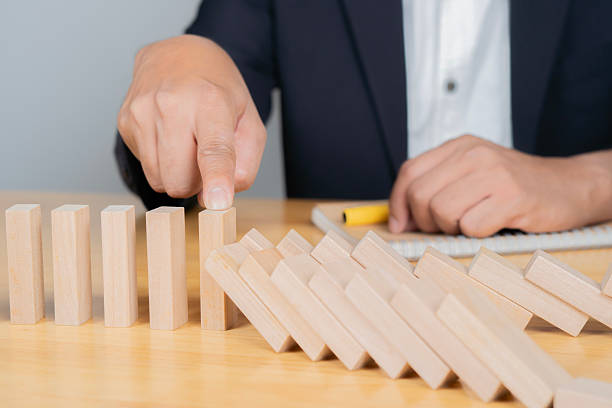 istock Business man placing wooden block on a tower concept risk control 2213997761