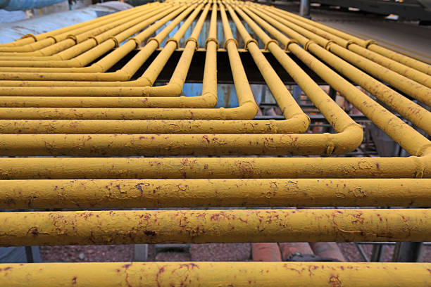 istock Oxidized yellow steel pipe in a factory 2213998262